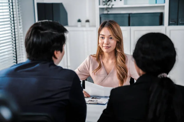 stock image A young female asian candidate tries to impress her interviewer by being competent. International company, multicultural environment in workplace.