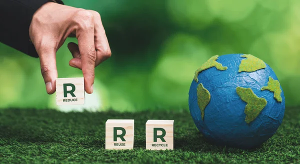 Businessman hand with paper globe and Reduce Reuse Recycle symbol cube for environment concept. Ethical business promotes clean energy and waste management for environmental protection policy. Alter