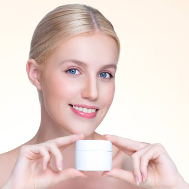 Personable beautiful perfect natural skin woman hold mockup tube moisturizer cream for skincare treatment product advertisement in isolated background with expressive facial and gesture expression.