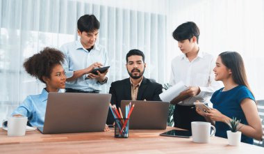 Mutlu iş adamları birlikte çalışır, şirket ofisinde tartışırlar. Profesyonel ve çeşitlilik takım çalışması iş planını bilgisayarda tartışır. Modern çok kültürlü ofis çalışanı. Uyum