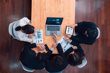 Top-view business team of financial data analysis meeting with business intelligence, report paper and dashboard on laptop for marketing strategy. Business people working together in office of harmony