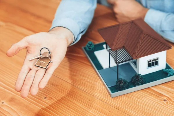 Real Estate Agent Presents House Key His Hand Wooden Table — Φωτογραφία Αρχείου