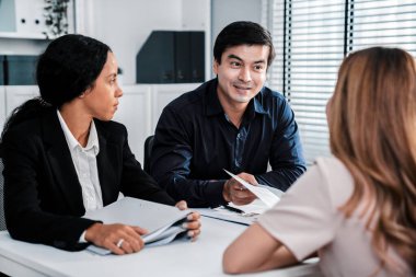 A young female asian candidate tries to impress her interviewer by being competent. International company, multicultural environment in workplace.