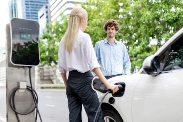Progressive Businessman Businesswoman Electric Car Parking Connected Public Charging Station — Stock Fotó