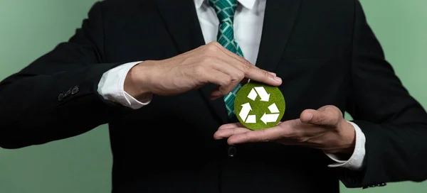 Corporate promoting sustainable and green business concept with businessman holding Recycle symbol paper as Reduce Reuse Recycle concept for waste management for clean environment idea. Alter