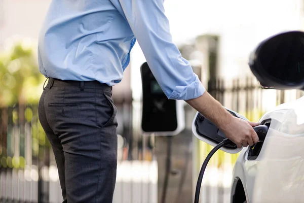 Closeup Progressive Man Holding Charger Plug Public Charging Station Electric — Stockfoto