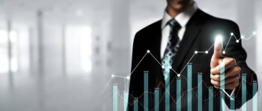 Businessman analyst working with digital finance business data graph showing technology of investment strategy for perceptive financial business decision. Digital economic analysis technology concept.