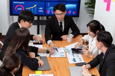 Business team of financial data analysis meeting with business intelligence, report paper and dashboard on laptop for marketing strategy. Business people working together to promote harmony in office.