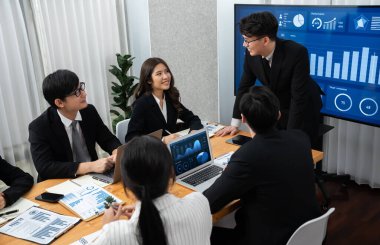 Business team of financial data analysis meeting with business intelligence, report paper and dashboard on laptop for marketing strategy. Business people working together to promote harmony in office.