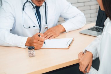 Profesyonel üniformalı doktor hastanedeki ya da klinikteki hastayı muayene ediyor. Sağlık, tıbbi ve doktor servis konsepti. Jivy