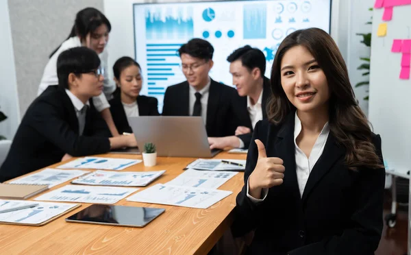 Stock image Focus portrait of female manger, businesswoman in the harmony meeting room with blurred of colleagues working together, analyzing financial paper report and dashboard data on screen in background.