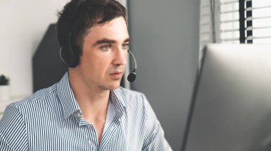 Competent male operator working with customers in the office. Concept of an operator, customer service agent working in the office.