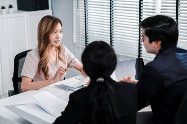 A young female asian candidate tries to impress her interviewer by being competent. International company, multicultural environment in workplace.