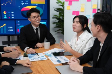 Business team of financial data analysis meeting with business intelligence, report paper and dashboard on laptop for marketing strategy. Business people working together to promote harmony in office.