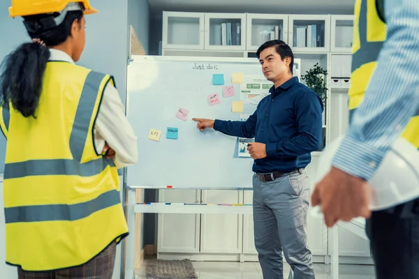 stock image A team of investor and competent engineers brainstorming on the whiteboard to find new ideas and making plans. The idea of a team gather ideas together.