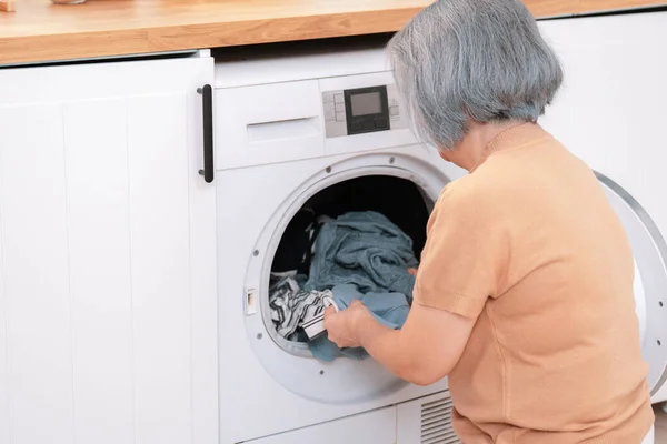 Contented Senior Housewife Doing Laundry Laundry Room Clothes Washing Machine — Foto de Stock