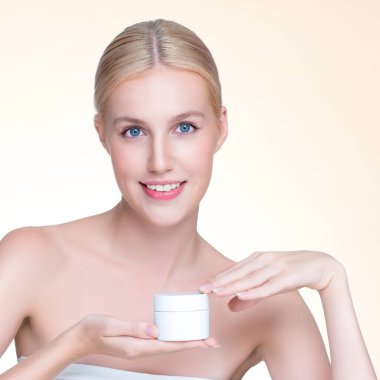 Personable beautiful perfect natural skin woman hold mockup jar moisturizer cream for skincare treatment product advertisement in isolated background with expressive facial and gesture expression.