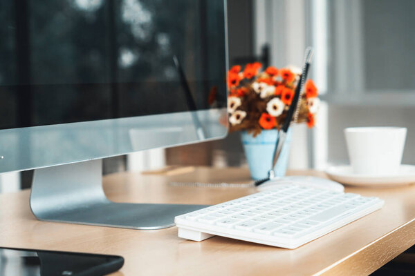 Close up keyboard desktop PC computer on table in small modern office or home office . Trendy workplace interior. Jivy