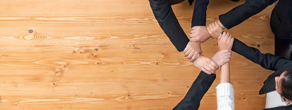 stock image Top view cohesive group of business people join hands stack together, form circle over meeting table for copyspace. Colleagues working to promote harmony and synergy team building concept in workplace