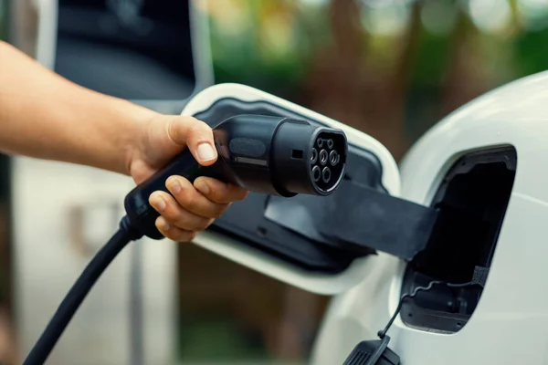 Hand Inserting Charging Plug Electric Vehicle Focus Shot Blurred Background — 图库照片