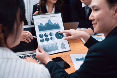 Business team of financial data analysis meeting with business intelligence, report paper and dashboard on laptop for marketing strategy. Business people working together to promote harmony in office.