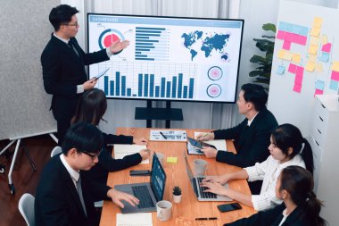 Confidence and asian businessman give presentation on financial analyzed by business intelligence in dashboard report to other people in board room meeting to promote harmony in workplace.