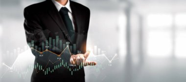 Businessman analyst working with digital finance business data graph showing technology of investment strategy for perceptive financial business decision. Digital economic analysis technology concept.
