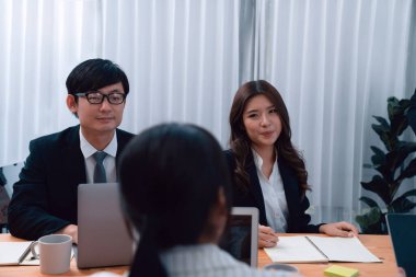 Business team of financial data analysis meeting with business intelligence, report paper and dashboard on laptop for marketing strategy. Business people working together to promote harmony in office.