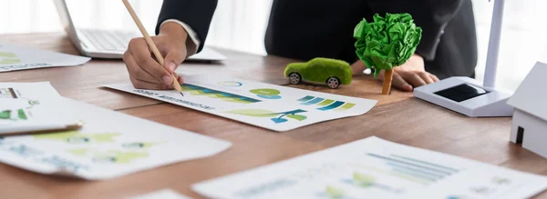 Businessman planning for green business strategy in office with paper documents focused on eco-friendly and energy sustainable policy to reduce CO2 emission for green environment. Trailblazing