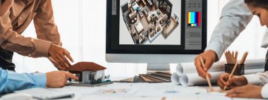 İç mimar tasarımcı grubu, daha kesin tasarım için planlar ve dizüstü bilgisayar ekran mimari yazılımı üzerinde birlikte tartışıyorlar. Modern ev tasarımı ve yenileme. İçgörü