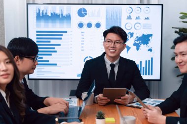 Business team of financial data analysis meeting with business intelligence, report paper and dashboard on laptop for marketing strategy. Business people working together to promote harmony in office.