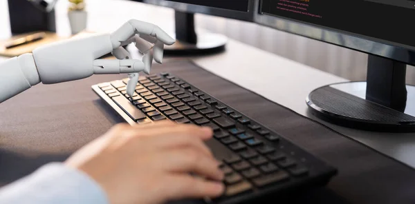 stock image Program coding automation by generative artificial intelligence or AI concept. Collaboration between robotic hand and human software developer solving, debugging or writing script.Trailblazing