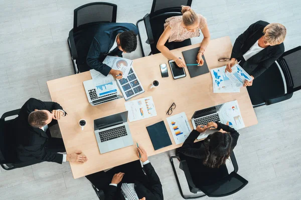 stock image Business people group meeting shot from top view in office . Profession businesswomen, businessmen and office workers working in team conference with project planning document on meeting table . Jivy