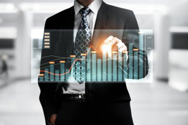 Businessman analyst working with digital finance business data graph showing technology of investment strategy for perceptive financial business decision. Digital economic analysis technology concept.