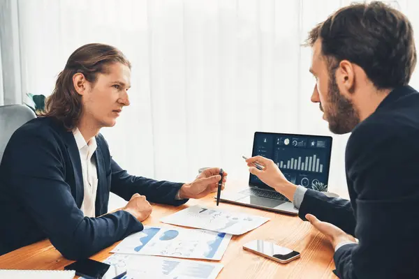 stock image Busy analyst team in office analyzing financial data analysis for marketing strategy in workspace using BI dashboard with graph and chart on laptop screen to improve business performance. Entity