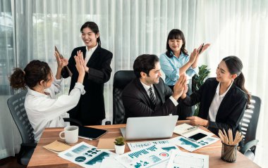 Bir grup mutlu iş adamı beşlik bir jest ve başarılı bir takım çalışması yapıyor. Çeşitli yarış bürosu çalışanları şirket ofisinde pazarlama planlamasında ilerleme kaydettikten sonra kutlama yapıyorlar. Habiliment