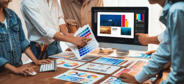 Grafik tasarımcı logo ve grafik sanatları yoğun sanat atölyesinde, dizüstü bilgisayar gösterim atölyesinde. Yaratıcı tasarım için renk paleti ve desen deneniyor. Panorama çekimi. İnceleyin