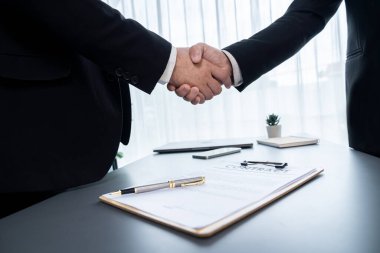 İki profesyonel, yakın el sıkışma ile iş anlaşmasını başarıyla tamamlayarak, ortaklık anlaşmasını imzaladı. Yasal belge ve el sıkışma iki şirket arasında resmi bir anlaşma. Coşkulu