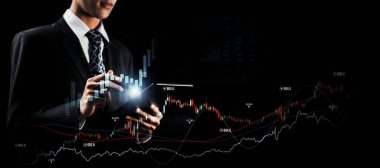 Businessman analyst working with digital finance business data graph showing technology of investment strategy for perceptive financial business decision. Digital economic analysis technology concept.