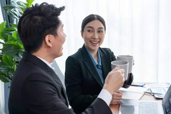 两名亚洲办公室工作人员在工作场所一起喝咖啡休息 同事们一边微笑着和社交活动 一边举杯咖啡 在公司的工作空间中增加友好的工作环境 — 图库照片