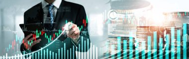 Businessman analyst working with digital finance business data graph showing technology of investment strategy for perceptive financial business decision. Digital economic analysis technology concept.