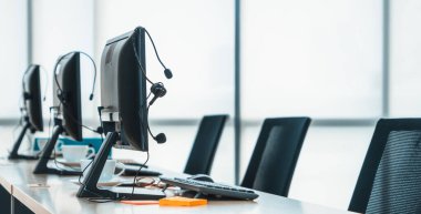 Çağrı merkezi bilgisayarları ve kulaklıklar ofiste. Telefonla pazarlama, müşteri destek acentesi telefon görüşmesinde hizmet sağlıyor. Jivy