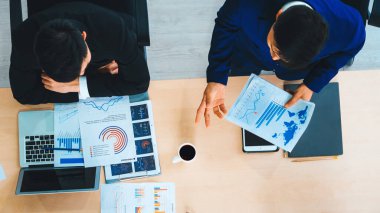 İş adamları grup toplantısı ofiste yukarıdan çekildi. İş kadınları, iş adamları ve ofis çalışanları toplantı masasında proje planlama belgeleriyle takım konferansında çalışıyorlar. Jivy