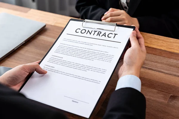 stock image Businessman review agreement document before signing contract. Reading carefully to ensure trade deal align with business goals. Professionalism for business decision making concept. Jubilant