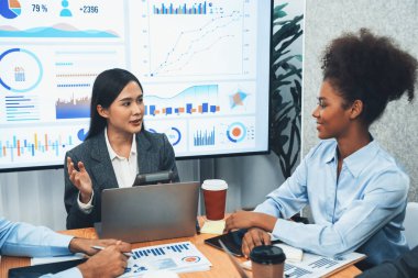 Genç Asyalı iş kadını modern toplantıda TV ekranında veri analizi paneli sunuyor. Bir grup iş adamıyla konferans odasında iş sunumu. Uyum