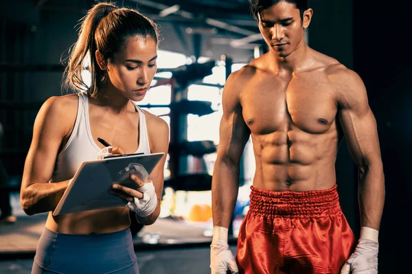 stock image Muay Thai boxer step on weight scale for boxing class designation by weight measurement before boxing fight match. Dedicated athlete fitness and physical boxers body readiness. Impetus