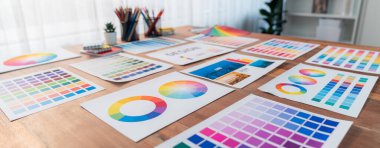 Panorama shot of various color palette idea papers arranged neatly on workspace table for graphic design concept. Color swatches and selection for unique digital art design. Scrutinize clipart