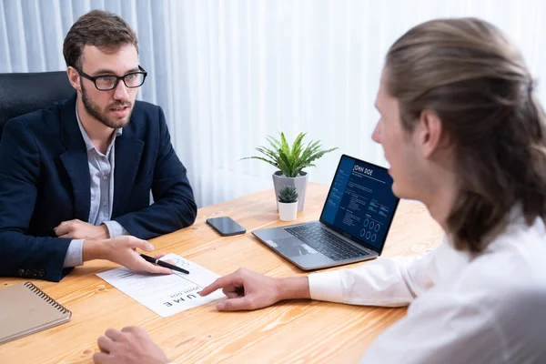 stock image Job candidate engaging conversation with interviewer during job interview. Job applicant present work experience and qualification by digital resume on laptop and CV paper to HR manager. Entity