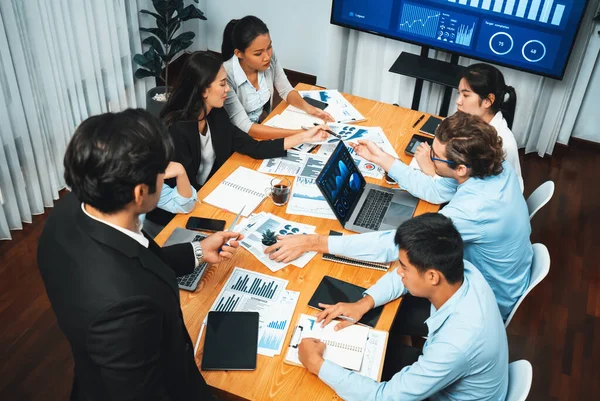 stock image Diverse group of business analyst team analyzing financial data report. Finance data analysis chart and graph dashboard show on TV screen in meeting room for strategic marketing planning. Habiliment