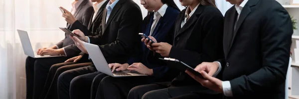 亚洲求职者穿着相同的衣服坐在候车室里等待求职面试 办公室职员或商人在狭小的房间里一起工作 使用笔记本电脑和电话 开拓性的 — 图库照片
